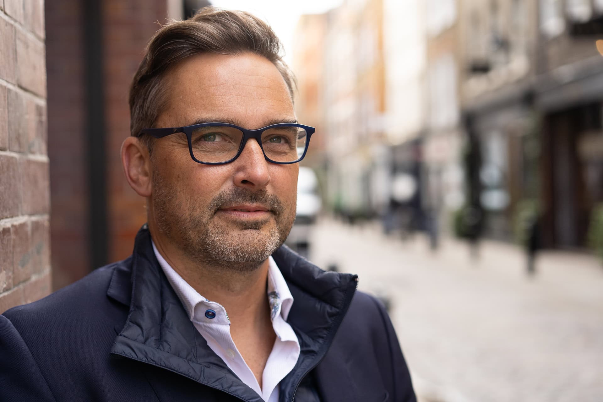 Phil Askew, London brand photographer, capturing a confident coach's portrait with natural light.