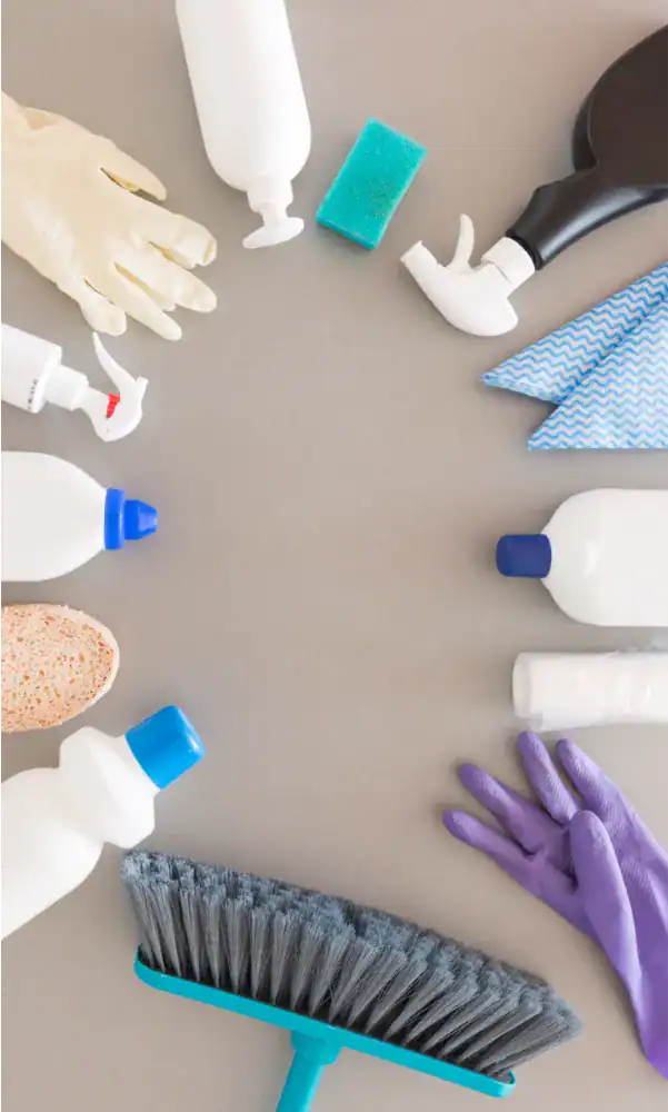 Cleaning supplies and gloves arranged in a circle for home maintenance or cleaning service.