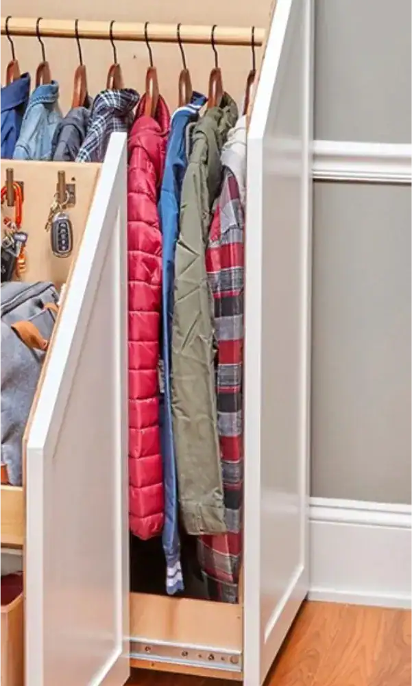 Slim wardrobe with hanging jackets and shirts, custom made for organised storage.