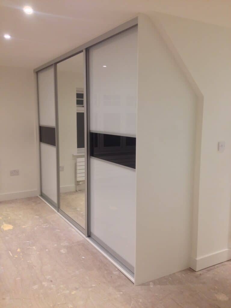 Built-in sliding wardrobe with custom doors for modern interior design.