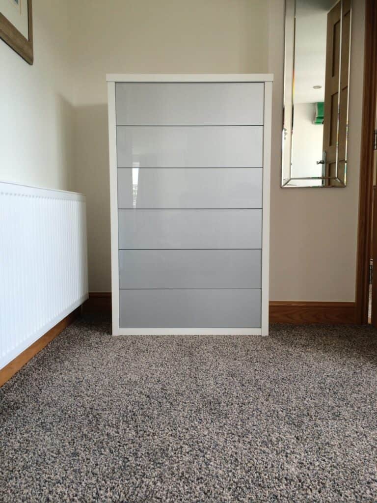 Modern grey and white custom-made storage cabinet for living space storage solutions.