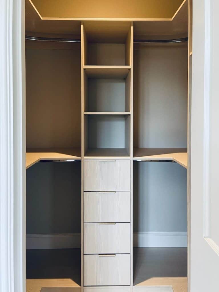 Custom made walk-in wardrobe with bespoke shelving and drawers by Made 2 Measure Interiors.