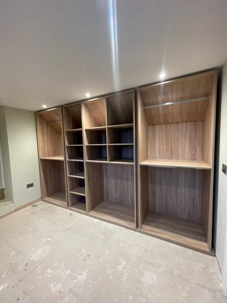 Custom made wood storage unit for fitted wardrobes by Made 2 Measure Interiors.