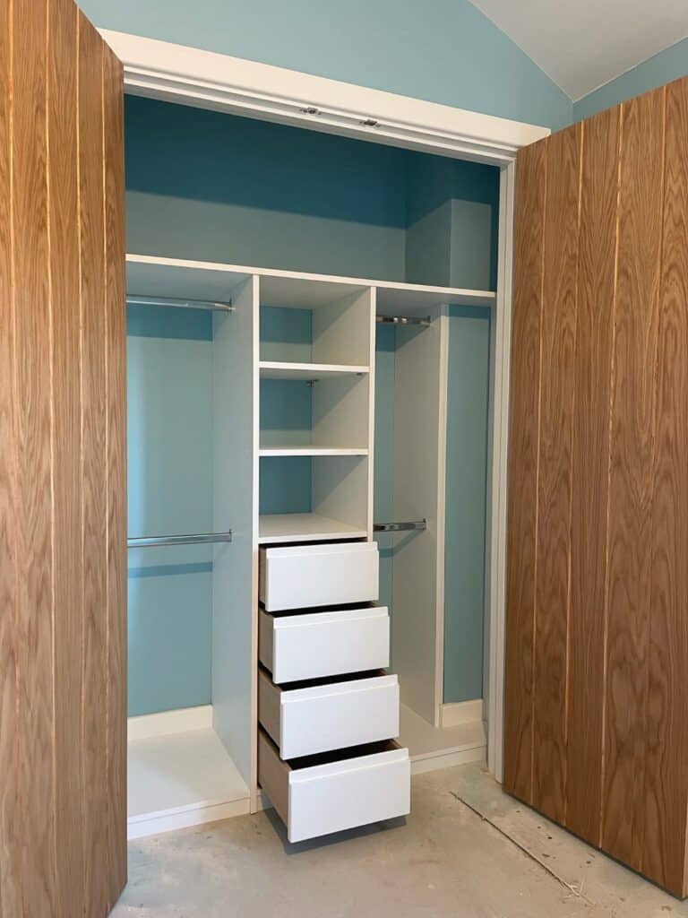 Custom made fitted wardrobe with drawers and hanging space, designed for optimal storage and organisation.