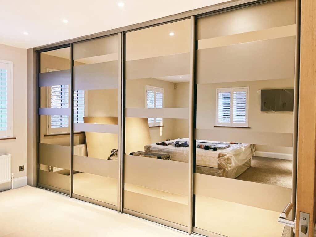 Bespoke sliding wardrobe doors with mirror finish, custom storage solutions, Made 2 Measure Interiors in UK.