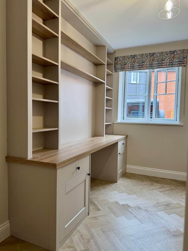 Bespoke home office installation with tailored shelving and desk for modern workspace needs.