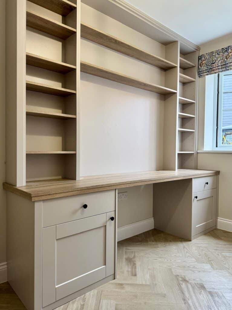 Bespoke home office storage with custom shelving and cabinetry for modern professional workspaces.