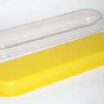 Yellow protective cover for safety equipment with clear lid.