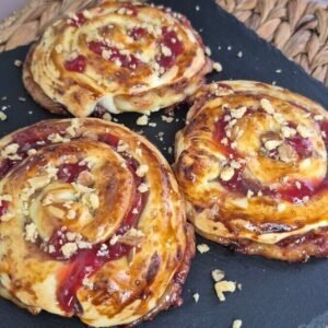 Pastry jam rolls on a dark plate