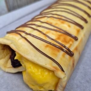 Sour Cherry Vanilla Pudding Cake Roll on a plate