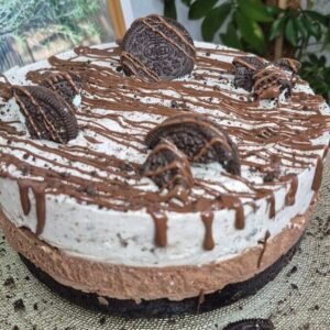 No-bake Nutella Oreo cake topped with Oreo cookies and chocolate drizzle.