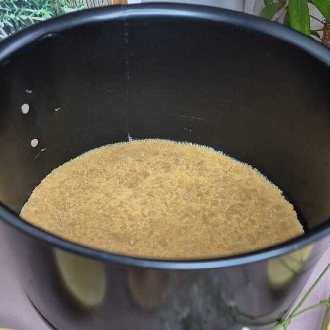 Simple golden graham cracker crust in a baking pan, perfect for quick desserts.