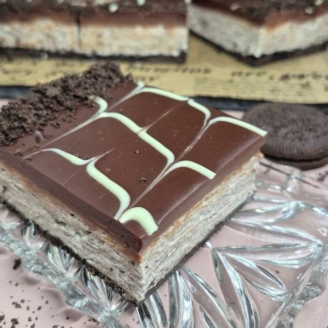 Rich chocolate dessert with white chocolate drizzle and cookie crumbs on top. Perfect quick treat.