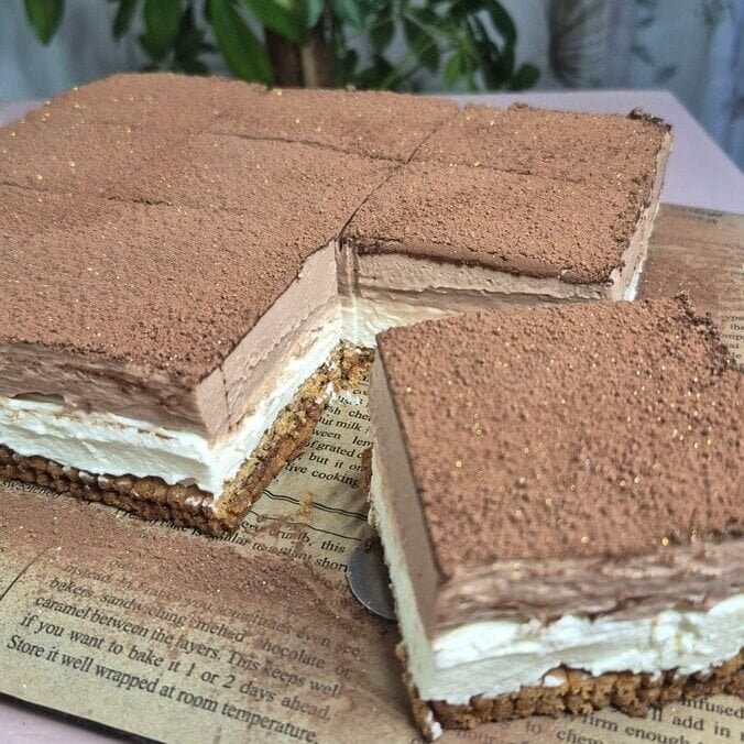No-bake Nutella biscuit cake slices with double mascarpone cream filling, dusted with cocoa powder