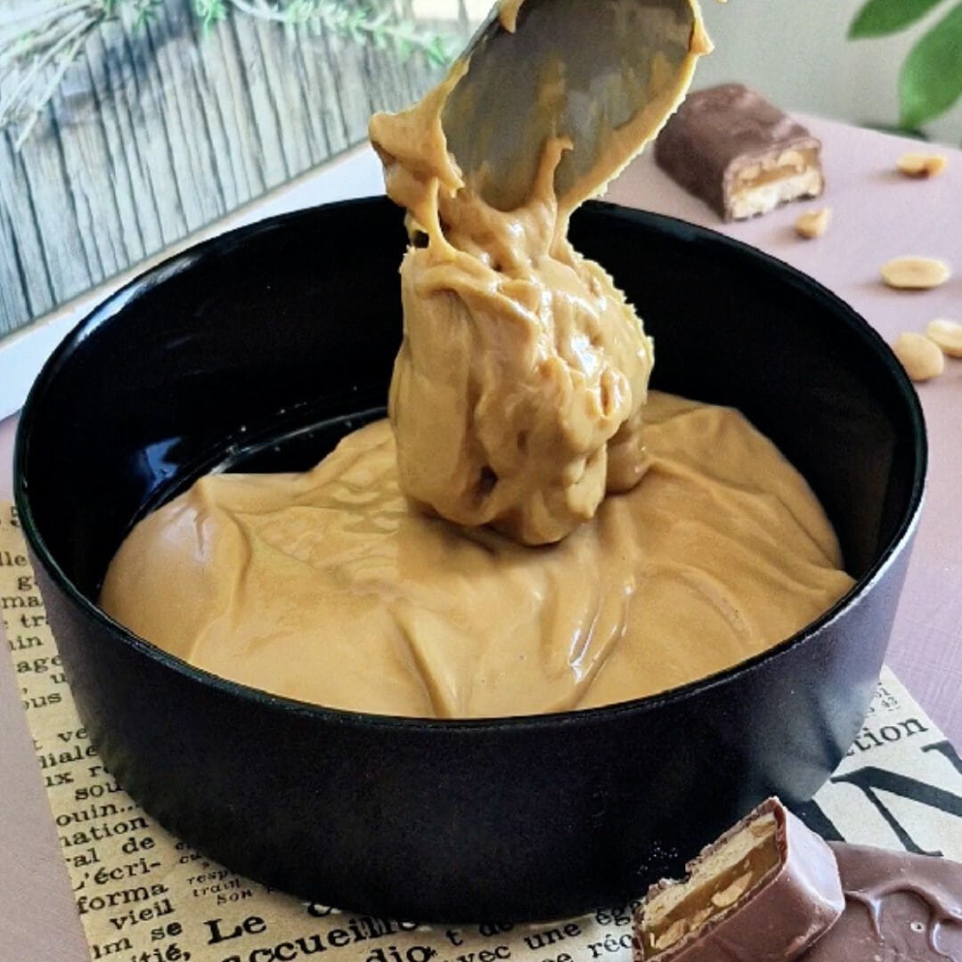Delicious peanut butter mousse in a black bowl, perfect for quick treats.