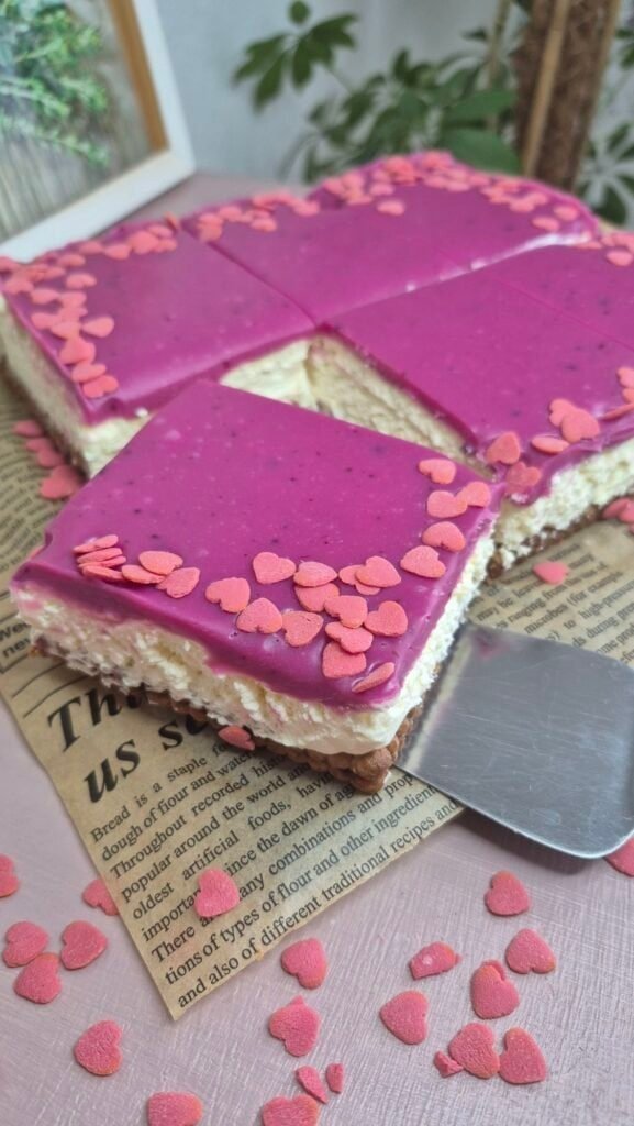 Valentine’s no-bake Nutella biscuit cake with a slice removed, showing the mascarpone layer and pink ganache topping.