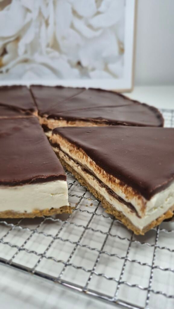 Nutella cake slices with biscuit base, cream filling, and chocolate topping