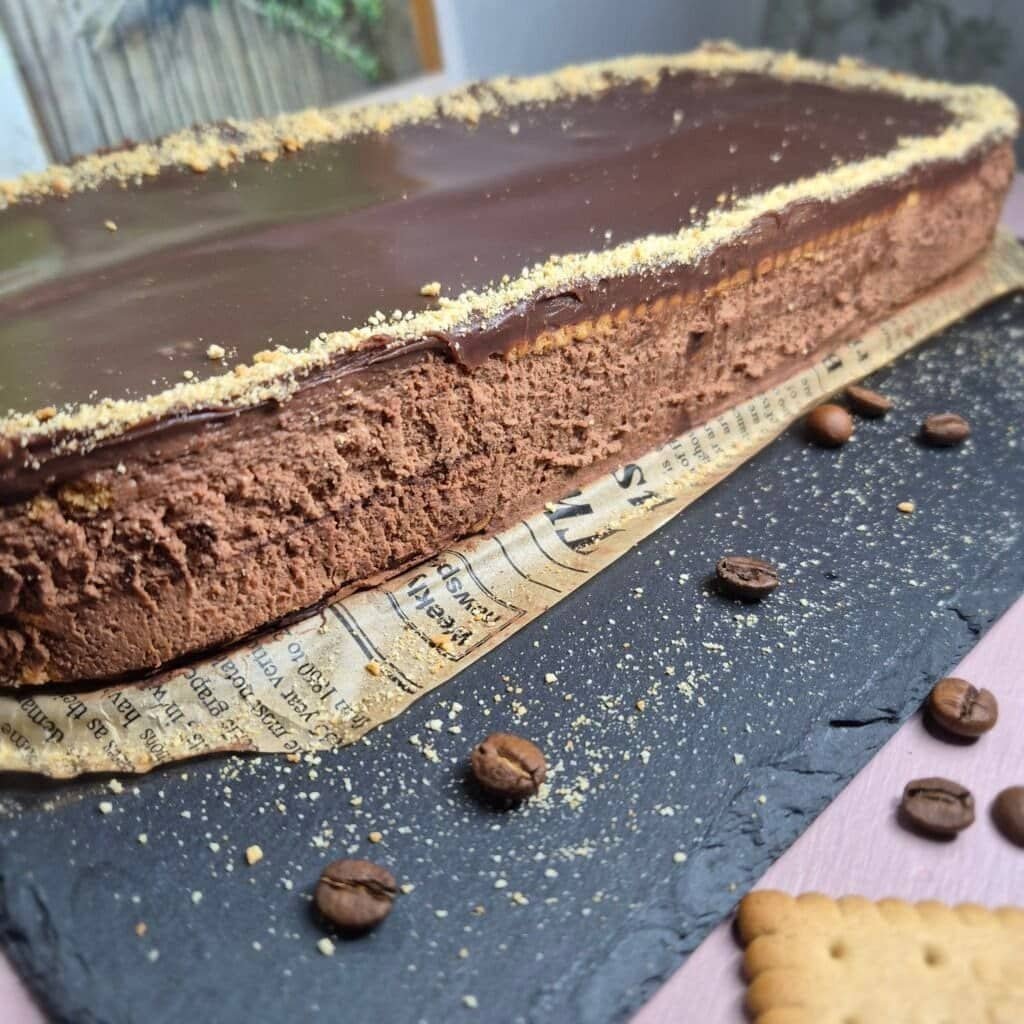 Chocolate biscuit cake with creamy chocolate filling and glossy chocolate topping