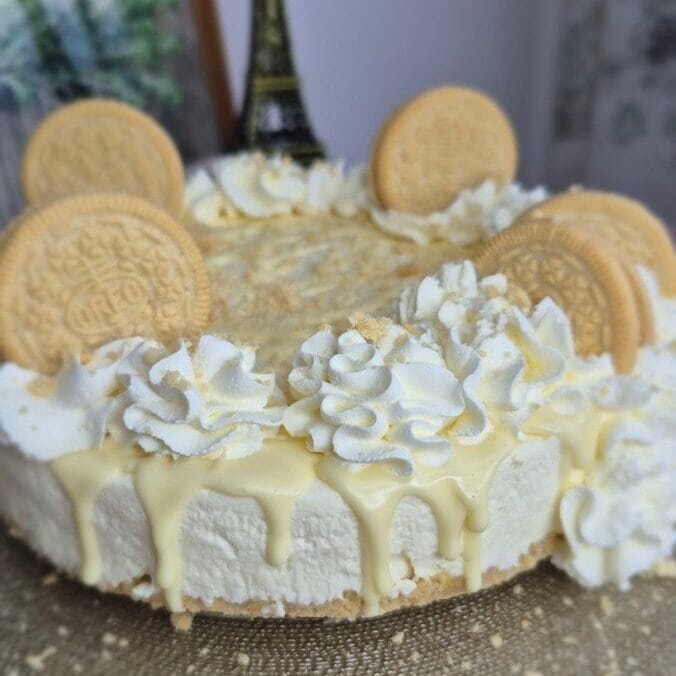 Golden Oreo cheesecake with mascarpone topping, crushed cookies, and whole Golden Oreo biscuits