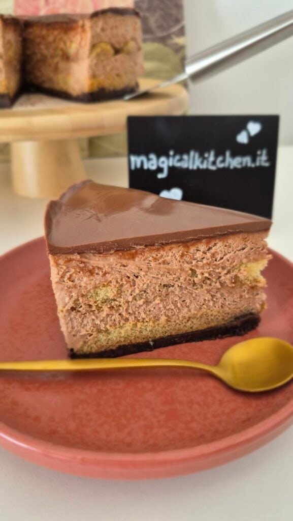 Slice of Nutella Oreo tiramisu cake on a brown plate with a gold spoon, with the whole cake in the background