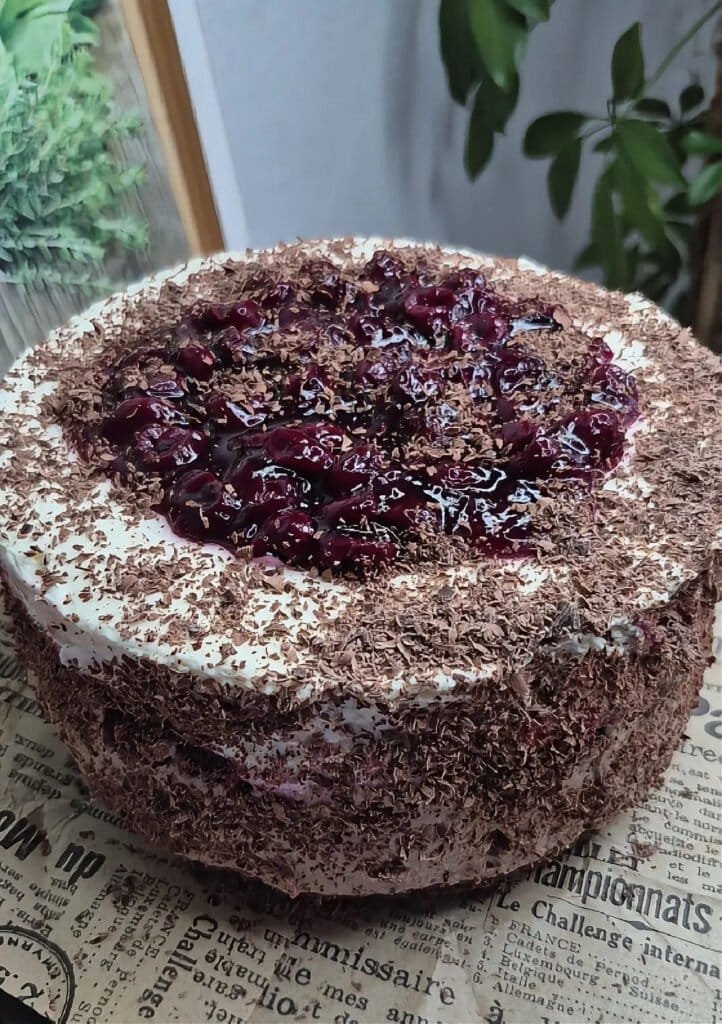 Whole no-bake Black Forest cake with mascarpone filling, cherry topping, and chocolate crumb coating