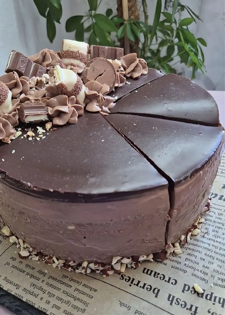 Nutella sponge cake with mascarpone cream and chocolate ganache, cut into slices