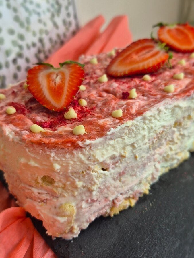 Strawberry tiramisu cake with cream layers and fresh strawberries on top