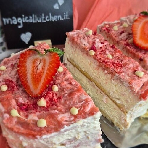 Strawberry tiramisu cake with mascarpone cream layers, ladyfingers, and fresh strawberries on top