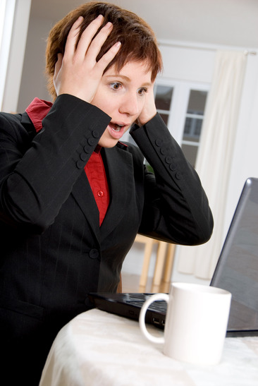 Surprised businesswoman at computer