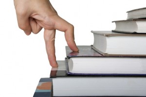 Fingers walk up book stairs