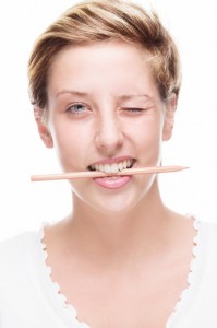 woman winking with pencil in her mouth