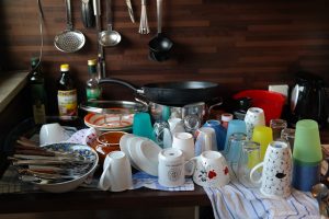 Pile of dishes spread out on a counter top