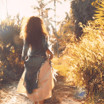 young woman in a dress on a dirty path in a tropical location
