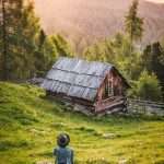 Person Sitting in Front of Brown and Black House