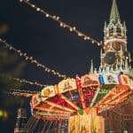 Colorful luminous carousel against Kremlin on Red Square at night
