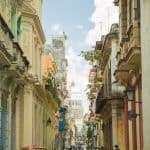 Crowded pedestrian street between old residential buildings in Havana Cuba on clear sunny weather