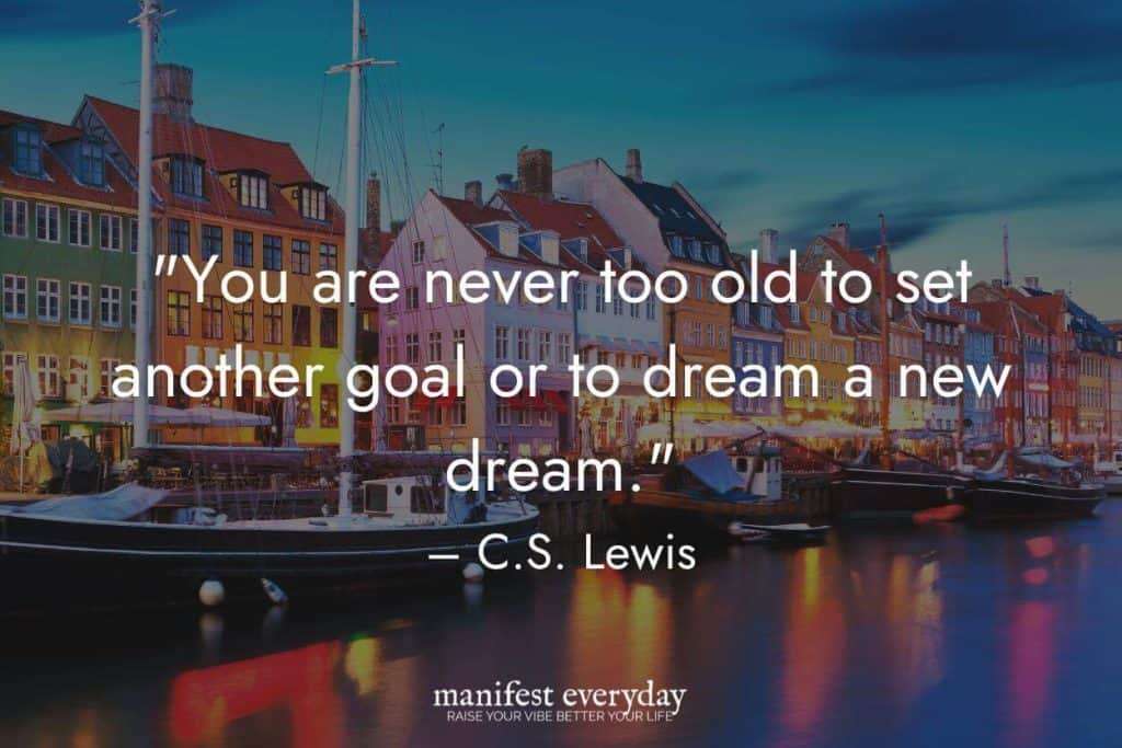 A scene in Bosa Italy with colorful houses, river and boats with quote text that reads "You are never too old to set another goal or to dream a new dream." - C.S. Lewis manifesteveryday.com