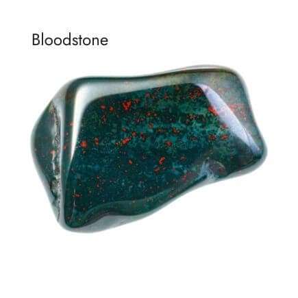 tumbled dark green, black with red flecks bloodstone crystal on white background