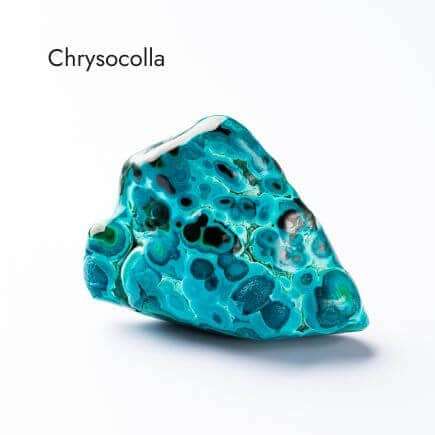 smooth, aqua and black colored chrysocolla stone on white background