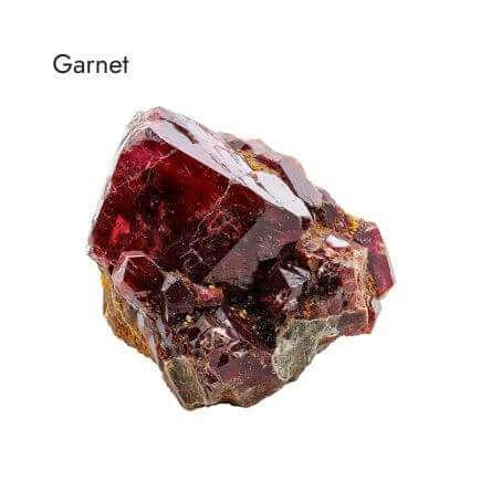 shiny, red, raw garnet stone on white background