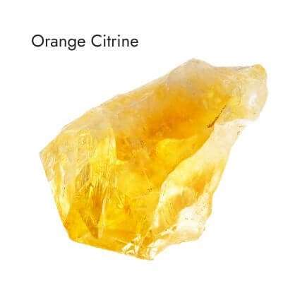 shiny, raw, orange citrine stone on white background