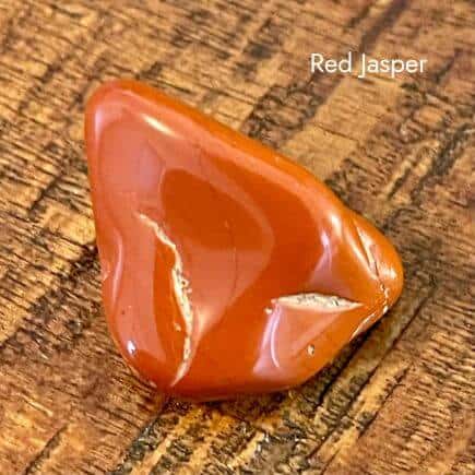 tumbled red jasper stone on white background