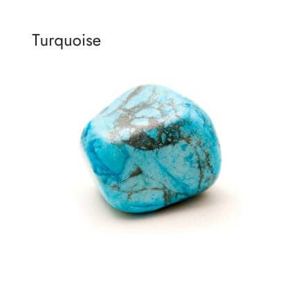 aqua and black colored, tumbled turquoise stone on white background