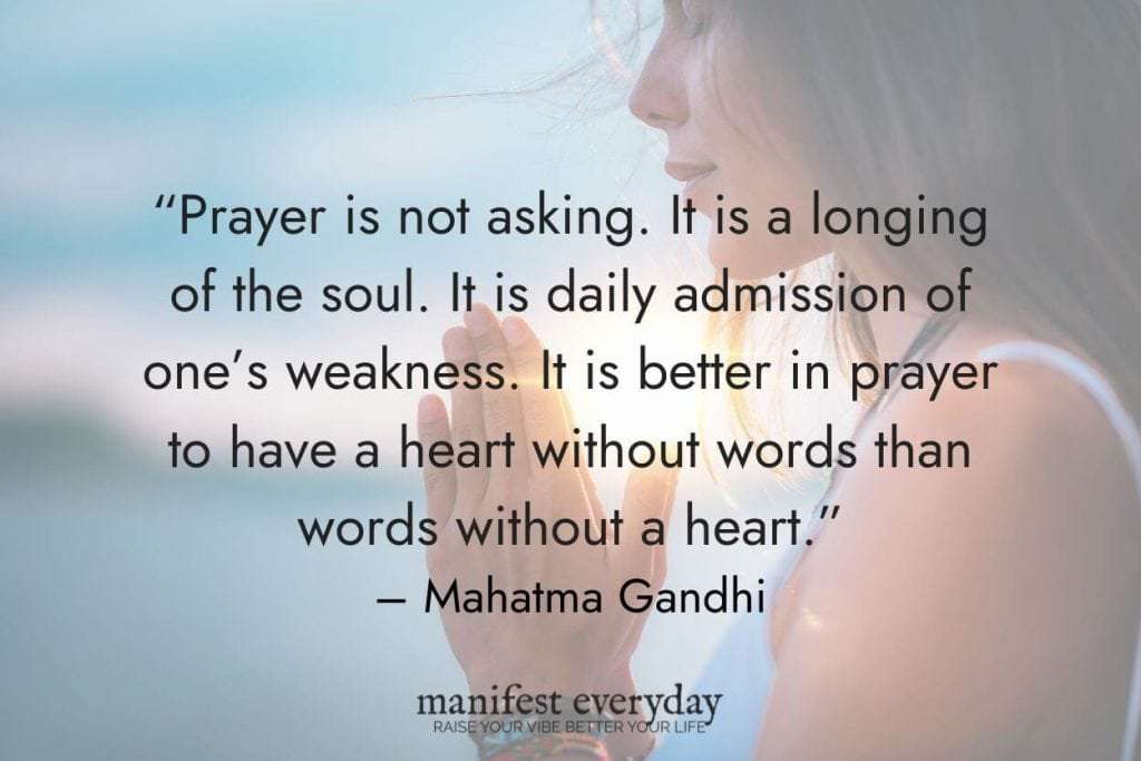 young woman praying at sunset with quote text that reads “Prayer is not asking. It is a longing of the soul. It is daily admission of one’s weakness. It is better in prayer to have a heart without words than words without a heart.” - Mahatma Gandhi manifesteveryday.com