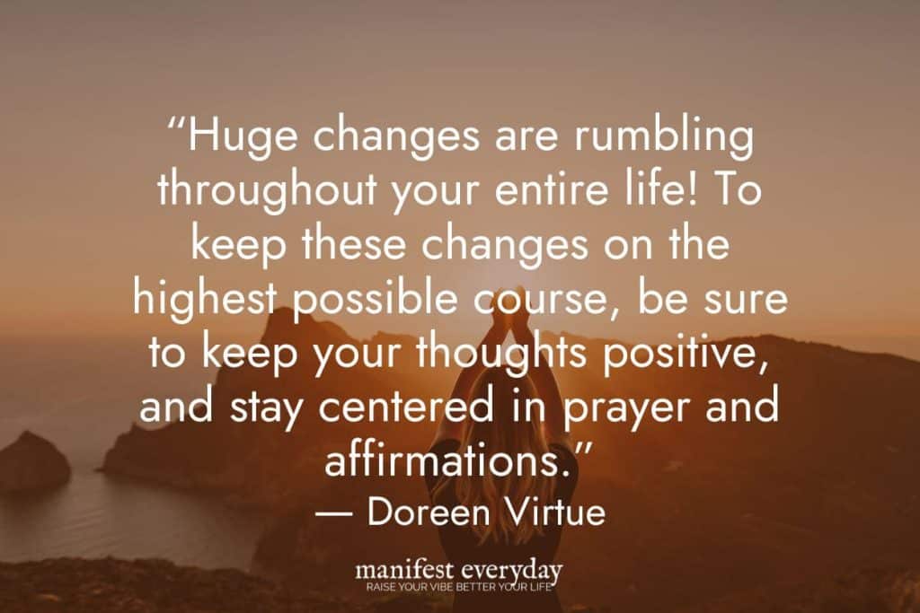 young woman on mountain top overlooking other mountains, water, and sky with arms raised with quote text that reads “Huge changes are rumbling throughout your entire life! To keep these changes on the highest possible course, be sure to keep your thoughts positive, and stay centered in prayer and affirmations.” ― Doreen Virtue manifesteveryday.com