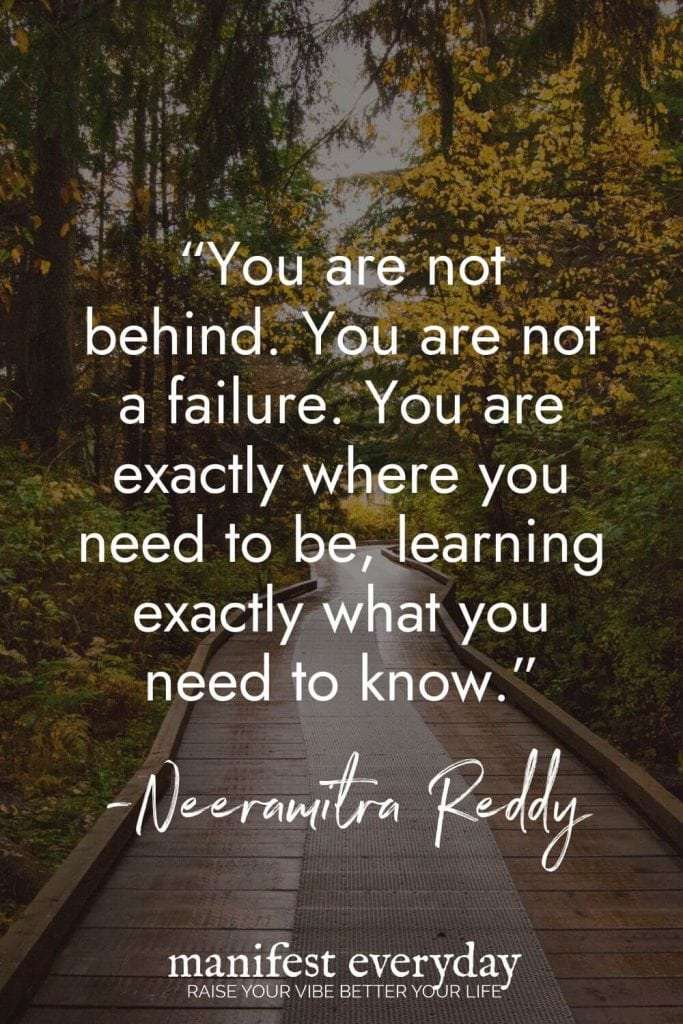 A wooden boardwalk through an autumn forest with golden leaves, featuring an inspirational self-care quote by Neeramitra Reddy: "You are not behind. You are not a failure. You are exactly where you need to be, learning exactly what you need to know." Perfect for when you're feeling overwhelmed. manifesteveryday.com