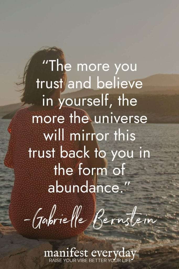 Woman in polka dot dress looking at ocean with inspirational law of attraction quote by Gabrielle Bernstein: The more you trust and believe in yourself, the more the universe will mirror this trust back to you in the form of abundance. More Quotes + Tips Inside → Read the Post! manifesteveryday.com