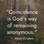 Serene forest scene with sunlight streaming through tall trees and the Albert Einstein quote: “Coincidence is God’s way of remaining anonymous.” The golden sunlight filtering through the trees symbolizes divine presence and spiritual awareness. The “manifest everyday” logo appears at the bottom with the tagline “RAISE YOUR VIBE BETTER YOUR LIFE.” manifesteveryday.com