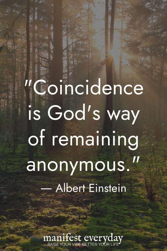 Serene forest scene with sunlight streaming through tall trees and the Albert Einstein quote: “Coincidence is God’s way of remaining anonymous.” The golden sunlight filtering through the trees symbolizes divine presence and spiritual awareness. The “manifest everyday” logo appears at the bottom with the tagline “RAISE YOUR VIBE BETTER YOUR LIFE.” manifesteveryday.com