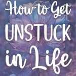 Close-up of delicate purple flower with white text overlay reading How to Get Unstuck in Life representing growth and transformation manifesteveryday.com